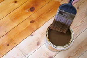 Close-up of someone varnishing a wooden floor